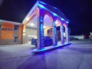 a gazebo with lights in front of a building at Alien Residence Inn in Pecos