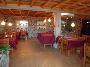 a restaurant with tables and chairs with purple table cloth at Posada El Castillo in Arequipa
