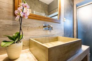 a bathroom with a sink with a plant in a vase at Louros Spa House in Mármara +84 photos