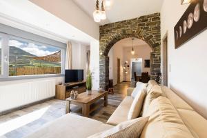 a living room with a couch and a large window at Louros Spa House in Mármara