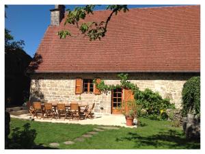 a group of chairs sitting outside of a stone house at A L'Ombre du Tilleul in Comiac