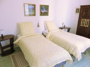 a bedroom with two beds and a table at Lemoniegites in Lemonie +36 photos