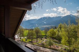 a window view of a park with mountains in the background at Beauty & Vital Hotel Maria in Carano