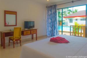 En eller flere senge i et værelse på Alona Vida Beach Hill Resort