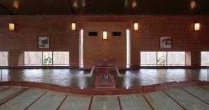 a large room with a dance floor and windows at 仙台秋保温泉 篝火の湯 緑水亭 in Sendai