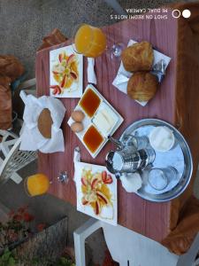 a picnic table with food and orange juice and bread at maison de vacance in Tafraout
