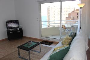 a living room with a couch and a table at Sunny one bed, sea view, larvotto beach, Monaco in Beausoleil