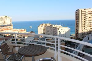 a balcony with a table and chairs and the ocean at Sunny one bed, sea view, larvotto beach, Monaco in Beausoleil