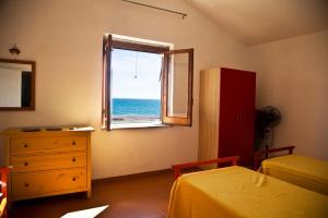- une chambre avec une fenêtre donnant sur l'océan dans l'établissement villa francesca e cristina, à Ferruzzano