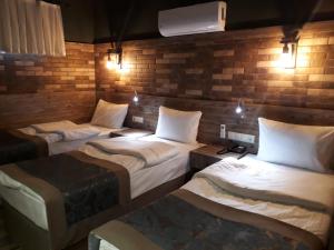 A bed or beds in a room at THE SARIGERME INN