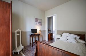 a white bedroom with a bed and a television at CR BnB Rozzano in Rozzano +7 photos