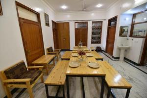 a dining room with wooden tables and chairs at Balbir Niwas Guesthouse Homestay in Udaipur