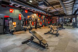 a gym with several exercise equipment in a room at Budapest Airport Hotel Stáció Wellness & Konferencia in Vecsés