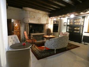 a living room with couches and a fireplace at LE LOGIS ST PERE in Sancerre