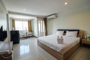 a bedroom with a bed with two candles on it at DD Place in Suphan Buri +23 photos
