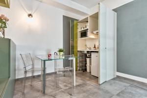 een keuken en eetkamer met een glazen tafel en stoelen bij CA'35 in Turijn