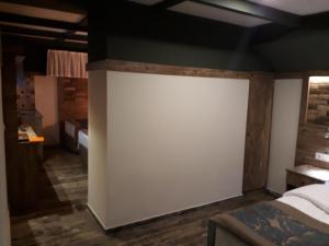 A bed or beds in a room at THE SARIGERME INN
