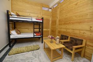 a room with two bunk beds and a table at Balbir Niwas Guesthouse Homestay in Udaipur