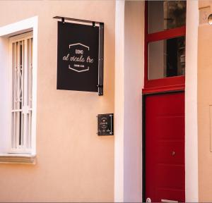 a red door with a sign that reads not all make fire at Al Vicolo tre in Sassari