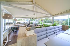 a room with a couch and a table with a laptop at Valamar Camping Krk in Krk