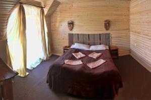 a bedroom with a bed with two towels on it at Oksamit Resort in Vorokhta