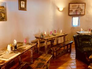 a dining room with wooden tables and a chair at Ranch Campo Palombaggia in Porto-Vecchio