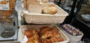 a basket filled with breads and other baked goods at Hotel De La Cite Rougemont in Paris