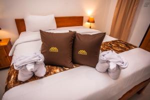 a hotel room with two beds with towels on them at Singgahan Bungalow by ecommerceloka in Nusa Penida