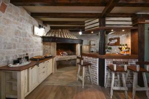 a kitchen with a stone wall and an oven at Villa Laurana ZadarVillas in Pakoštane +28 photos