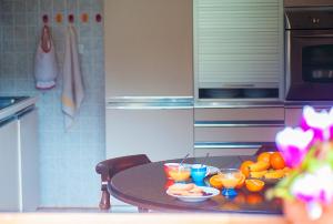a kitchen with a table with fruit and drinks on it at Le Terrazze di katia apartment in Riomaggiore