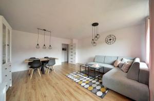 a living room with a couch and a table at Apart-Invest Apartament Pastelowy in Szklarska Poręba