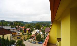 a view from a balcony of a small town at Apart-Invest Apartament Pastelowy in Szklarska Poręba