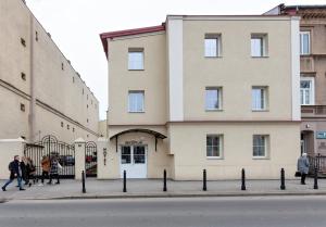 a building with people walking in front of it at HOTEL LUBLIN in Lublin