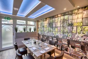 a dining room with a long table and chairs at La Barbarie Hotel by Eight Continents in St. Martin Guernsey