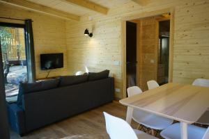 a living room with a couch and a table at Camping Maçanet de Cabrenys in Maçanet de Cabrenys