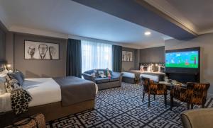 a hotel room with a large bed and a tv at Talbot Hotel Stillorgan in Stillorgan