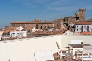 a view from the roof of a building with a table and chairs at Dorma Agora Cáceres in Cáceres