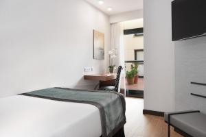 Ένα ή περισσότερα κρεβάτια σε δωμάτιο στο Exe Agora Cáceres