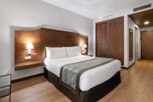 Ένα ή περισσότερα κρεβάτια σε δωμάτιο στο Exe Agora Cáceres