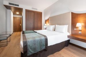 Ένα ή περισσότερα κρεβάτια σε δωμάτιο στο Exe Agora Cáceres