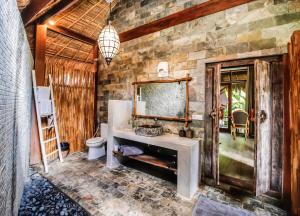 a bathroom with a sink and a mirror at La Cabane in Jimbaran