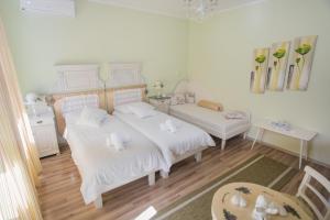 Postel nebo postele na pokoji v ubytování Shabby Chic Apartments