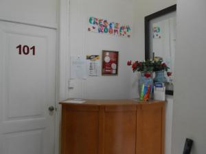 a room with a door and a cabinet with a plant on it at Crescent Rooms in Lisbon