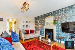 a living room with a couch and a fireplace at Causeway Coast Haven in Ballycastle