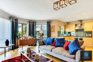 a living room with a couch with blue and red pillows at Causeway Coast Haven in Ballycastle