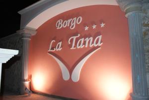 a sign on the side of a building at Hotel Ristorante Borgo La Tana in Maratea