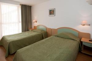 A bed or beds in a room at Hotel Longoza - All Inclusive
