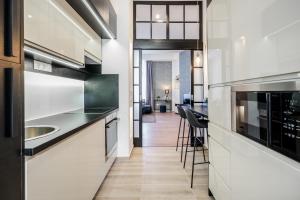 a kitchen with white cabinets and a counter top at BpR THRILL Design Home with A/C in Budapest