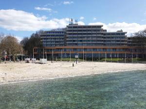 a large building on the beach next to the water at Appartement _An der Seebruecke_ in Glücksburg +17 photos