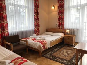 Łóżko lub łóżka w pokoju w obiekcie Pensjonat Adria